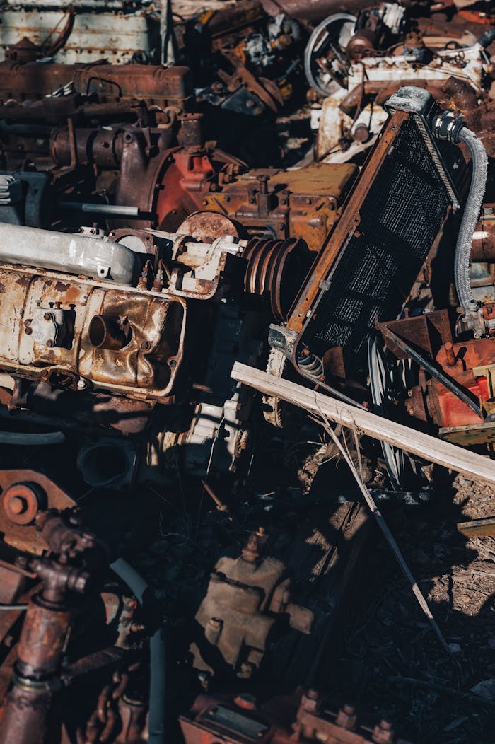 İzmir Hurdacı Close-up view of a heap of rusty, vintage auto parts in a junkyard, creating an industrial feel.
